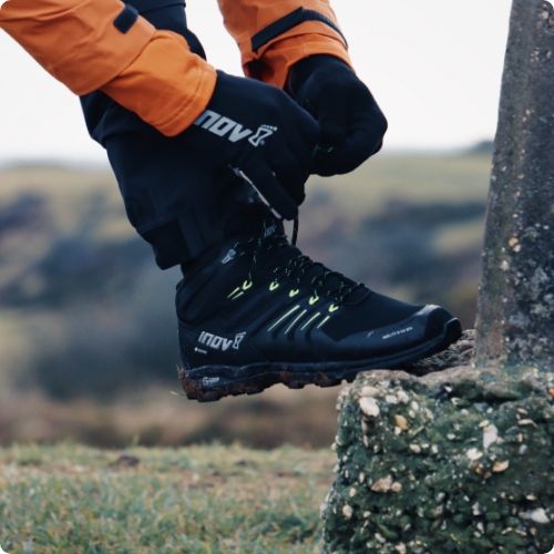 Hiker tying the laces of their Roclite G 345 GTX V2 boots