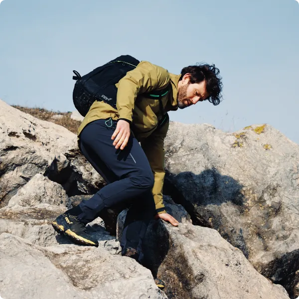 Man hiking over rocks while wearing the ROCLITE PRO G 400 GTX V2 boots